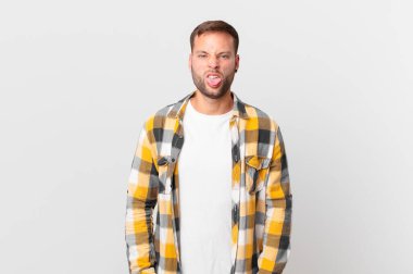 handsome blonde man feeling disgusted and irritated and tongue out