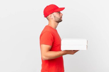 pizza deliver man on profile view thinking, imagining or daydreaming