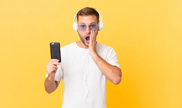 Feeling Shocked Scared Listening Music Headphones Smartphone — Zdjęcie stockowe