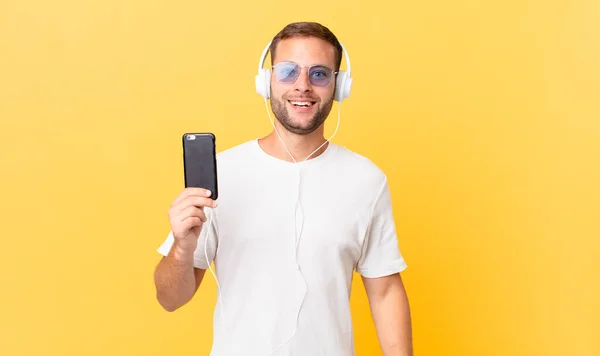 Looking Happy Pleasantly Surprised Listening Music Headphones Smartphone — Stock Photo, Image