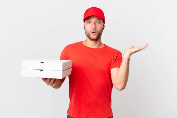 Pizza Deliver Man Looking Surprised Shocked Jaw Dropped Holding Object — Stockfoto