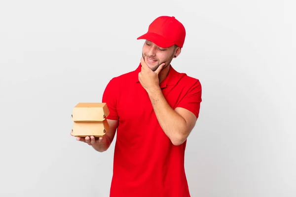 Burger Deliver Man Smiling Happy Confident Expression Hand Chin — Zdjęcie stockowe