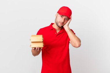 Hamburger dağıtan adam bıkkın, yorgun ve uykulu hissediyor.