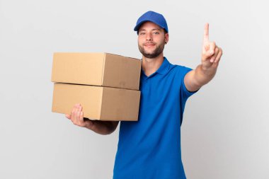 Paket teslimatçısı gülümsüyor ve arkadaş canlısı görünüyor.