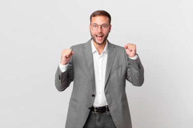 handsome businessman feeling shocked,laughing and celebrating success