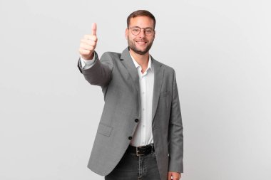 handsome businessman feeling proud,smiling positively with thumbs up