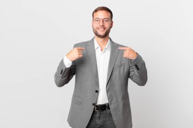 handsome businessman feeling happy and pointing to self with an excited