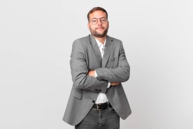 handsome businessman shrugging, feeling confused and uncertain