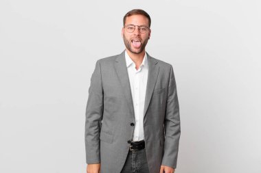 handsome businessman with cheerful and rebellious attitude, joking and sticking tongue out