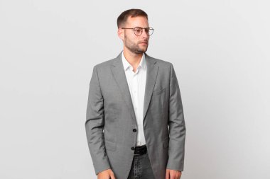 handsome businessman feeling sad, upset or angry and looking to the side