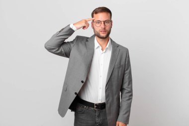 handsome businessman feeling confused and puzzled, showing you are insane