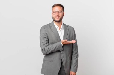 handsome businessman smiling cheerfully, feeling happy and showing a concept