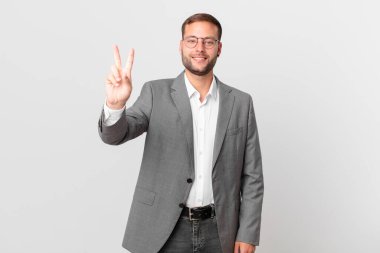 handsome businessman smiling and looking friendly, showing number two