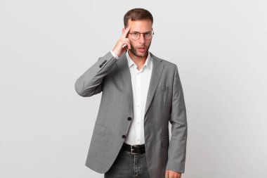 handsome businessman looking surprised, realizing a new thought, idea or concept