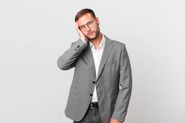 handsome businessman feeling bored, frustrated and sleepy after a tiresome