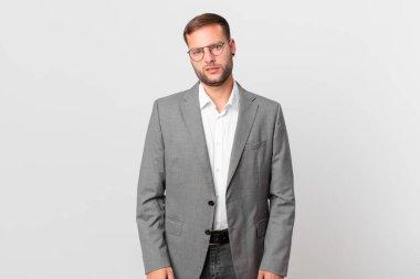 handsome businessman feeling puzzled and confused