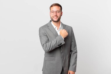 handsome businessman feeling happy and facing a challenge or celebrating