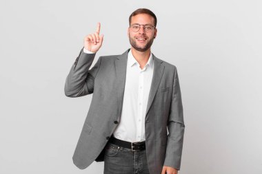 handsome businessman feeling like a happy and excited genius after realizing an idea