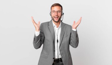 telemarketer businessman feeling happy and astonished at something unbelievable