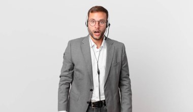 telemarketer businessman looking very shocked or surprised