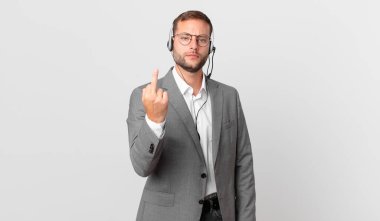 telemarketer businessman feeling angry, annoyed, rebellious and aggressive