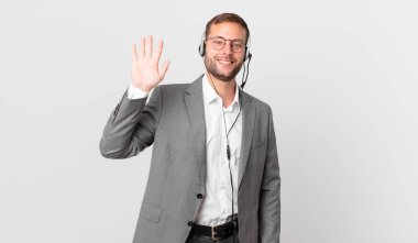 telemarketer businessman smiling happily, waving hand, welcoming and greeting you