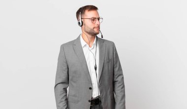 telemarketer businessman feeling sad, upset or angry and looking to the side