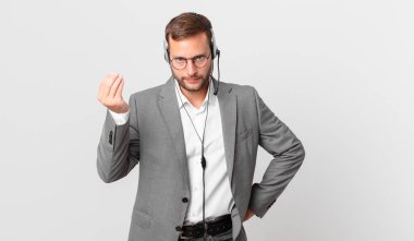 telemarketer businessman making capice or money gesture, telling you to pay