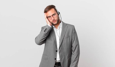telemarketer businessman feeling bored, frustrated and sleepy after a tiresome