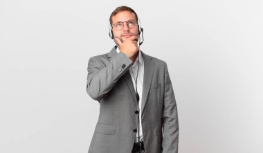 telemarketer businessman thinking, feeling doubtful and confused