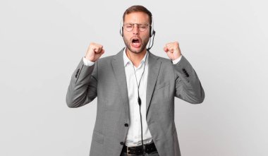 telemarketer businessman shouting aggressively with an angry expression
