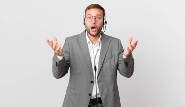 telemarketer businessman feeling extremely shocked and surprised