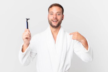 Yakışıklı sarışın adam mutlu hissediyor ve heyecanla kendini işaret ediyor. traş konsepti