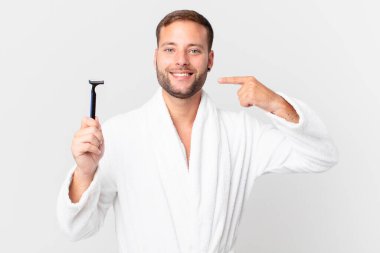 Yakışıklı sarışın adam kendi gülüşünü göstererek kendine güler. traş konsepti