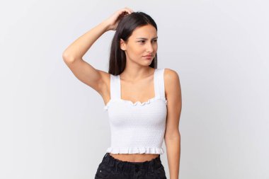 İspanyol güzel kadın şaşkın ve kafası karışık, kaşınıyor.