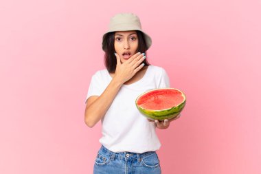 covering mouth with hands with a shocked