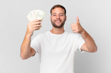 Dolar banknotları olan yakışıklı bir adam.