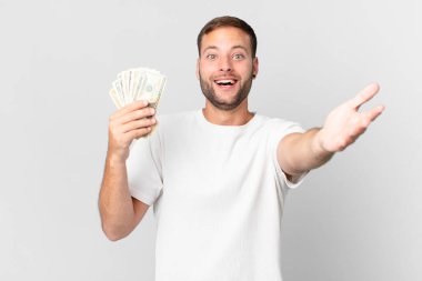 Dolar banknotları olan yakışıklı bir adam.