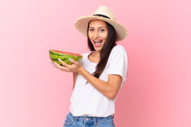pretty woman holding a watermelon slice