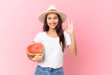 pretty woman holding a watermelon slice
