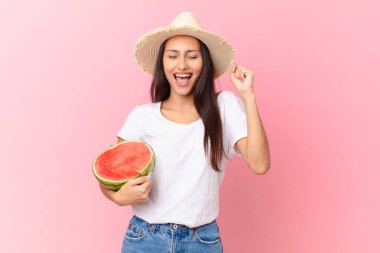 pretty woman holding a watermelon slice