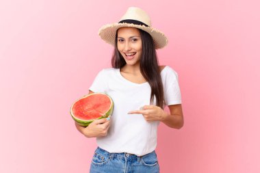 pretty woman holding a watermelon slice