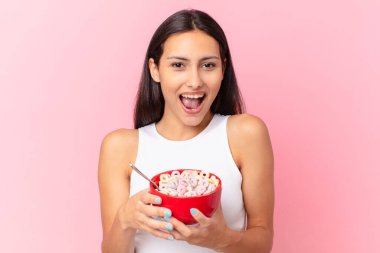 hispanic pretty woman with a breakfast bowl with flakes