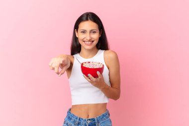 hispanic pretty woman with a breakfast bowl with flakes