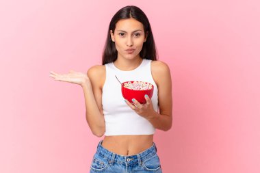 hispanic pretty woman with a breakfast bowl with flakes