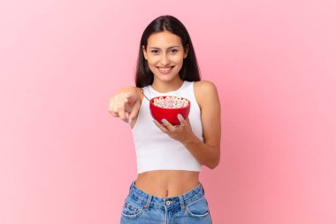 hispanic pretty woman with a breakfast bowl with flakes