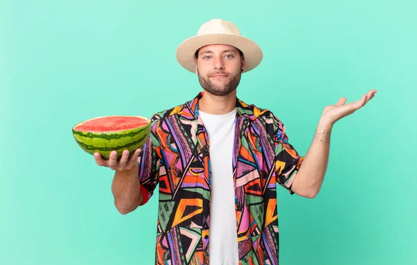 Handsome Traveler Man Feeling Puzzled Confused Doubting Holding Watermelon Holidays — Fotografia de Stock