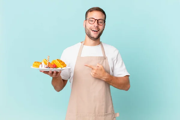 Young Handsome Blonde Man Looking Excited Surprised Pointing Side Cooking — Stock Photo, Image