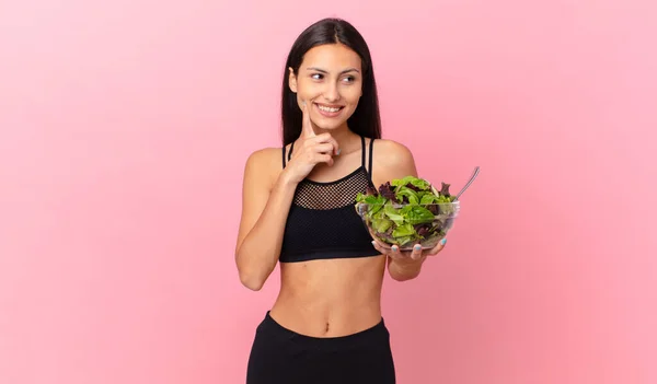 Hispanic Fitness Woman Smiling Happily Daydreaming Doubting Holding Salad — Fotografia de Stock