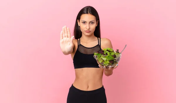 Hispanic Fitness Woman Looking Serious Showing Open Palm Making Stop — Fotografia de Stock